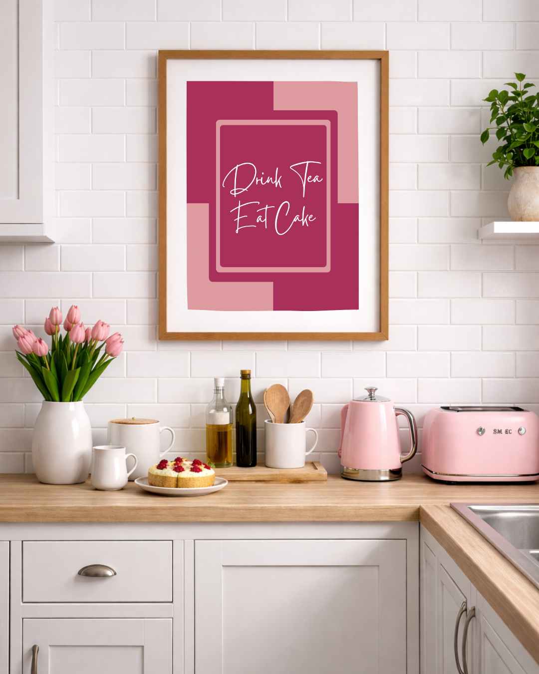 Pink “Drink Tea Eat Cake” kitchen wall art print with modern bold typography, ideal for tea lovers and baking themed kitchen decor.